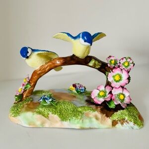 Charming Blue and Yellow Bird Figurine with Pink Flowers